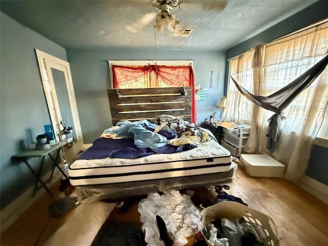 bedroom with hardwood / wood-style flooring and ceiling fan