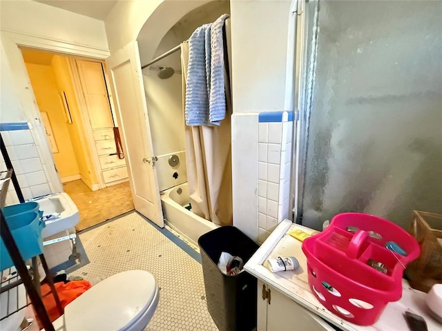 bathroom with shower / tub combo, toilet, and tile patterned floors