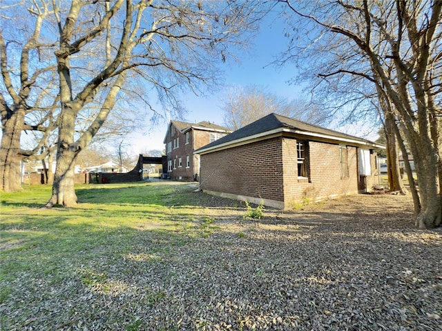 view of side of home with a yard