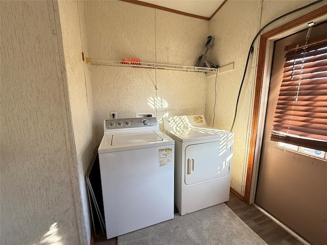 washroom featuring a textured wall, laundry area, ornamental molding, wood finished floors, and washing machine and dryer