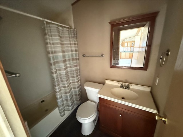 bathroom with vanity, shower / tub combo, and toilet