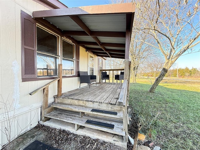 wooden terrace featuring a lawn
