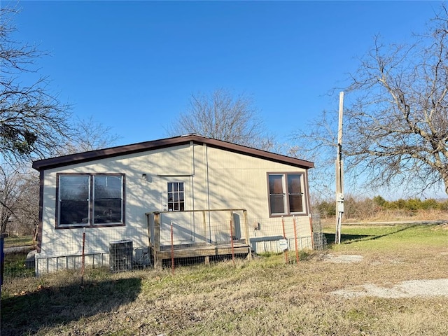 back of house with central AC unit