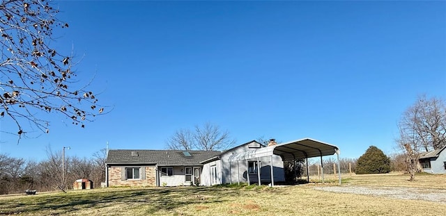 view of front of house with a front yard and a carport