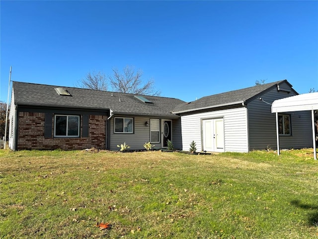 rear view of house with a yard