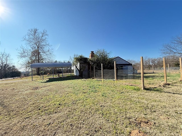 view of yard with a rural view and a carport