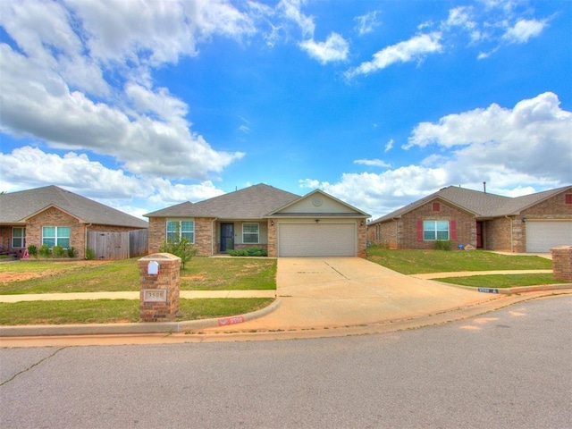 ranch-style home featuring a front yard and a garage