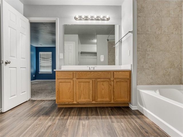 bathroom with vanity, hardwood / wood-style floors, and shower / bathing tub combination