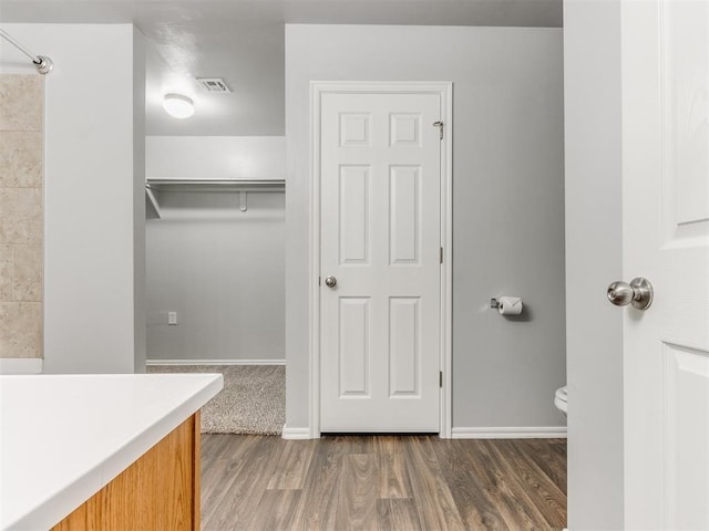 bathroom featuring hardwood / wood-style floors, vanity, and toilet