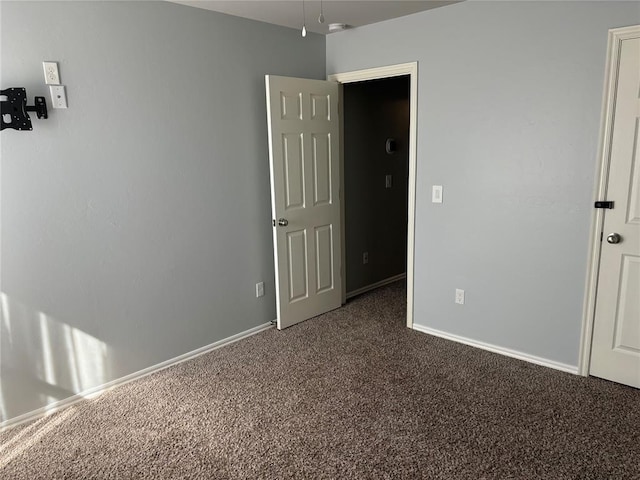 unfurnished bedroom featuring dark colored carpet