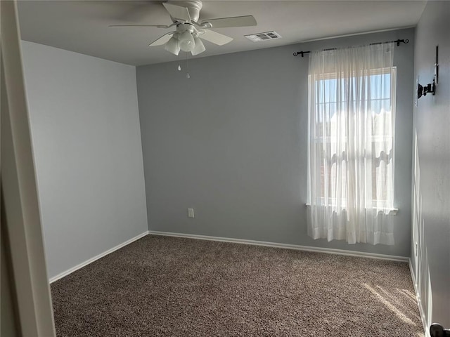 carpeted spare room with ceiling fan