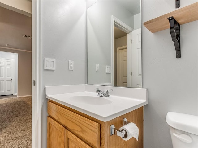 bathroom featuring vanity and toilet