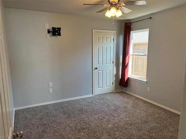 spare room with carpet and ceiling fan