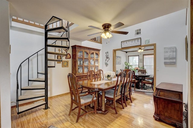 dining area with ceiling fan and light wood-type flooring