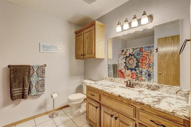 bathroom with tile patterned floors, vanity, and toilet