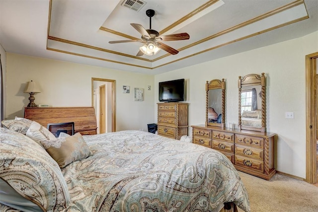 bedroom with a tray ceiling, ceiling fan, and light colored carpet