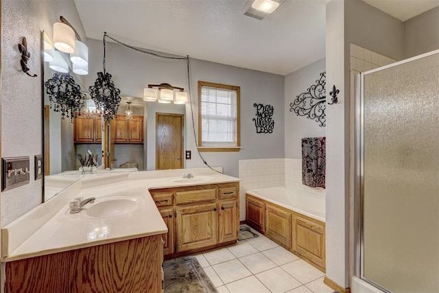 bathroom featuring tile patterned floors, vanity, and shower with separate bathtub