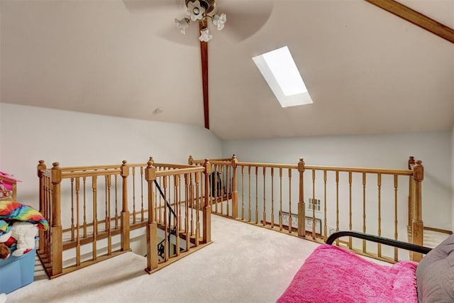 interior space with carpet flooring and vaulted ceiling with skylight