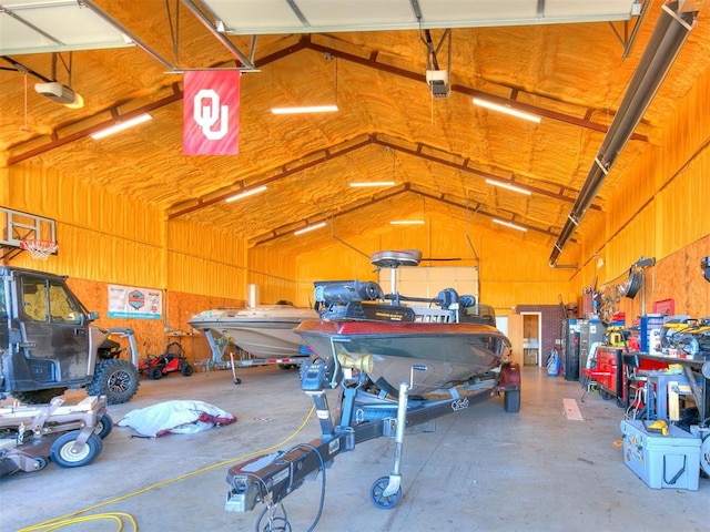 garage featuring a garage door opener and wooden walls