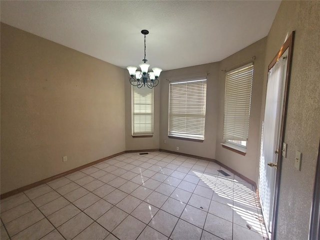 interior space featuring light tile patterned floors and a chandelier