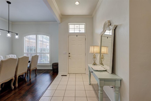 entrance foyer featuring ornamental molding and light wood-type flooring