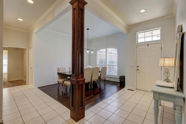 dining room featuring crown molding, light tile patterned flooring, and a healthy amount of sunlight