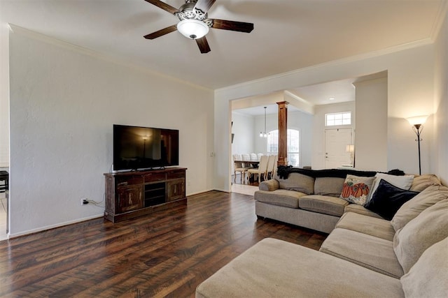 living room with dark hardwood / wood-style floors, crown molding, and ceiling fan with notable chandelier