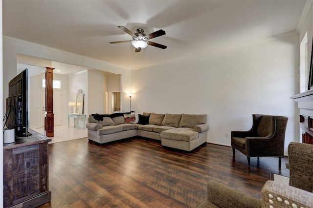 living room featuring dark hardwood / wood-style flooring, ceiling fan, and crown molding