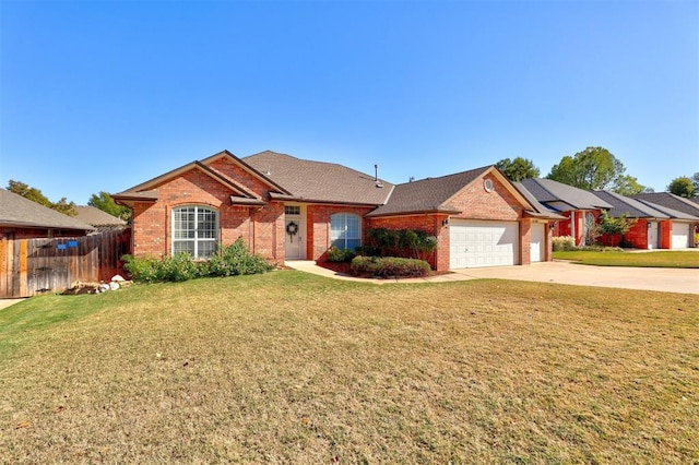 single story home featuring a front lawn and a garage