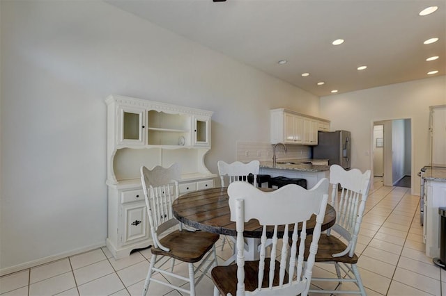 tiled dining area featuring sink