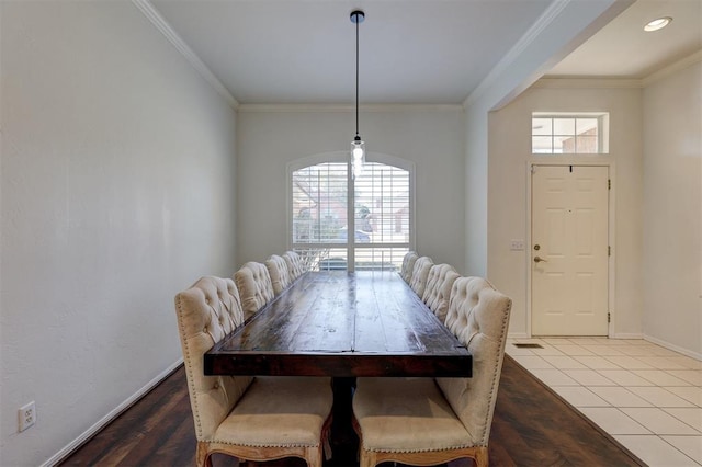 dining area featuring hardwood / wood-style flooring and crown molding