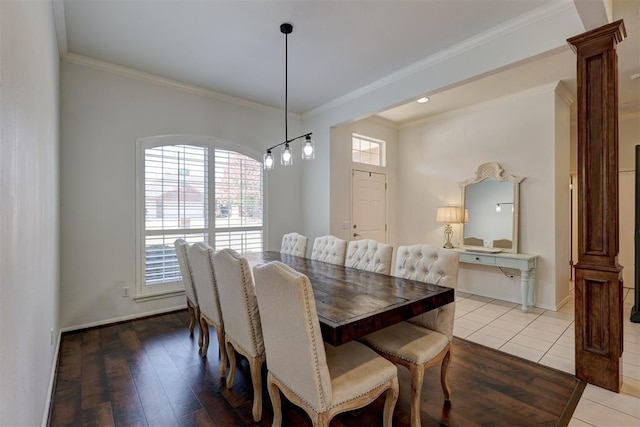 dining room with light wood-type flooring and crown molding