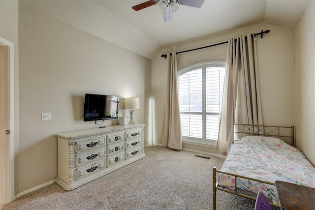 bedroom featuring light carpet, vaulted ceiling, and ceiling fan