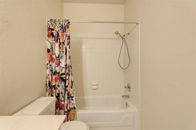 bathroom featuring shower / bath combination with curtain and toilet