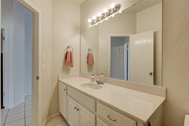 bathroom featuring tile patterned flooring and vanity