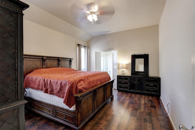 bedroom featuring ceiling fan, dark wood-type flooring, and lofted ceiling