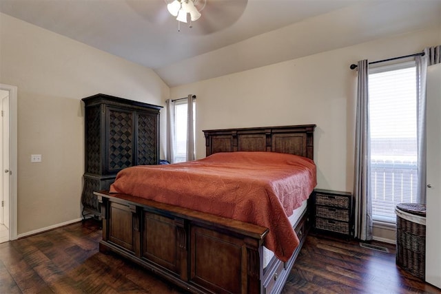 bedroom featuring ceiling fan, dark hardwood / wood-style flooring, lofted ceiling, and multiple windows