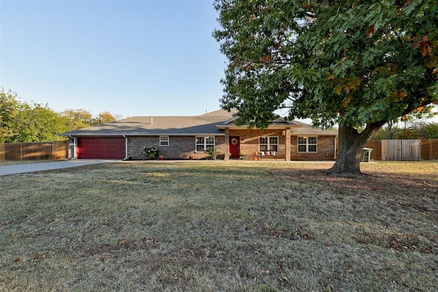 ranch-style home with a front lawn and a garage