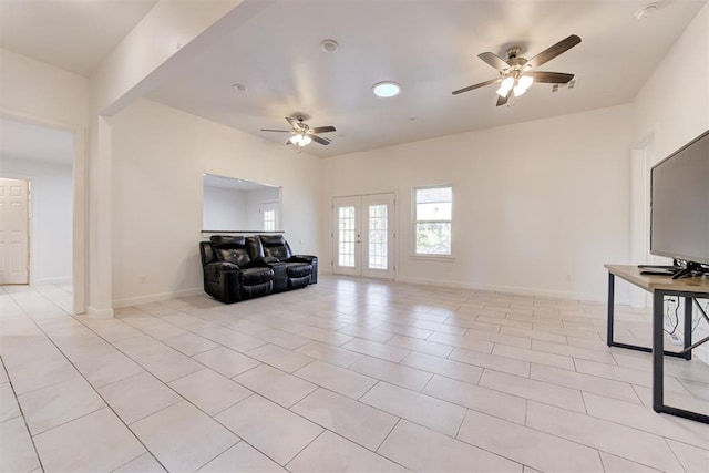 living area with ceiling fan, french doors, and light tile patterned flooring