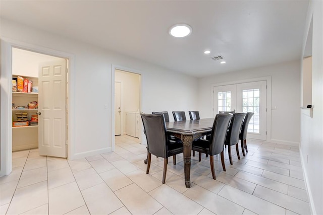 dining area with light tile patterned flooring and french doors