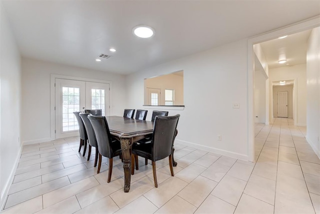 dining area featuring light tile patterned floors and french doors