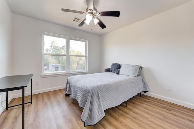 bedroom with ceiling fan and light hardwood / wood-style flooring