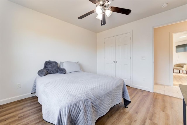 bedroom featuring a closet, light hardwood / wood-style flooring, and ceiling fan