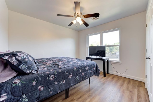 bedroom with light wood-type flooring and ceiling fan