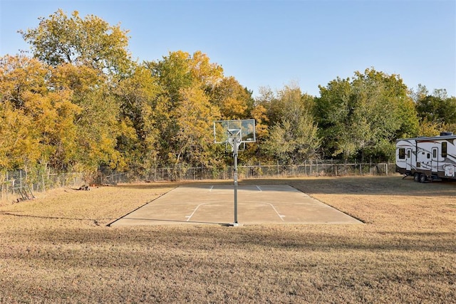 view of basketball court featuring a yard