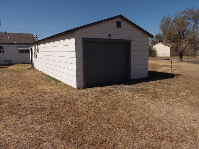 garage featuring a lawn