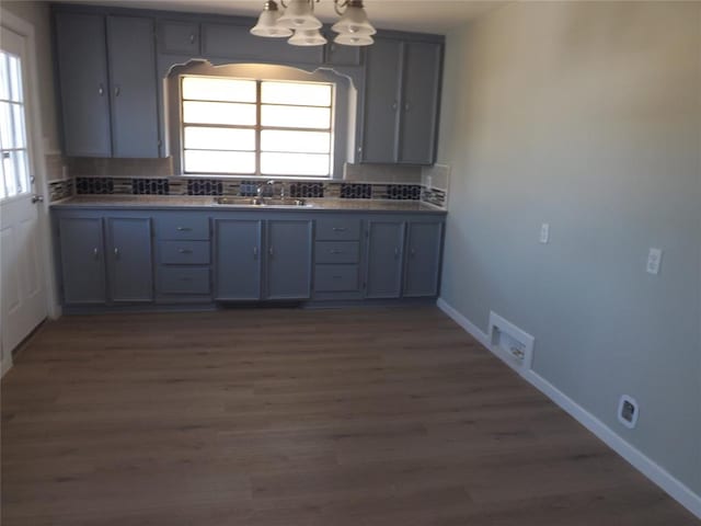 kitchen featuring tasteful backsplash, gray cabinetry, and plenty of natural light