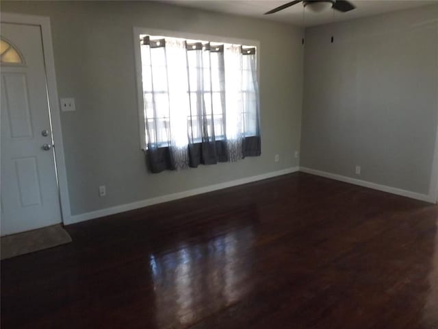 foyer entrance featuring ceiling fan and dark wood-type flooring