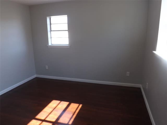 spare room featuring dark hardwood / wood-style flooring