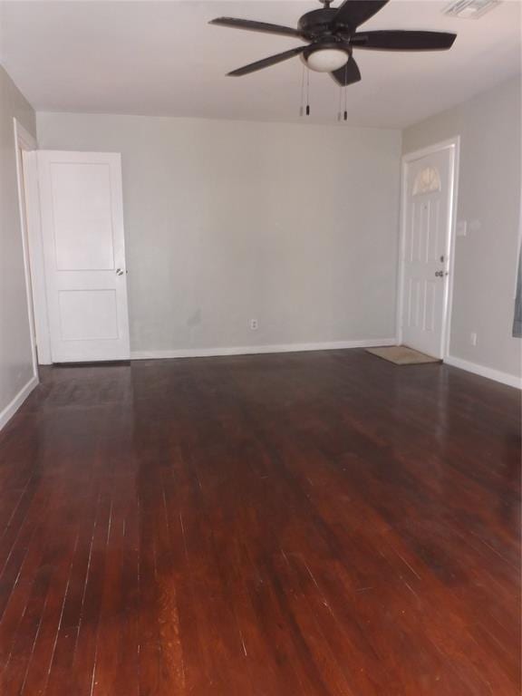 spare room with dark hardwood / wood-style floors and ceiling fan